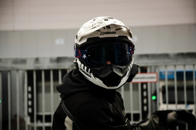 a person wearing a black jacket and a motorcycle helmet