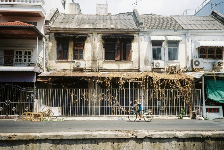 a woman is riding a bike down a street