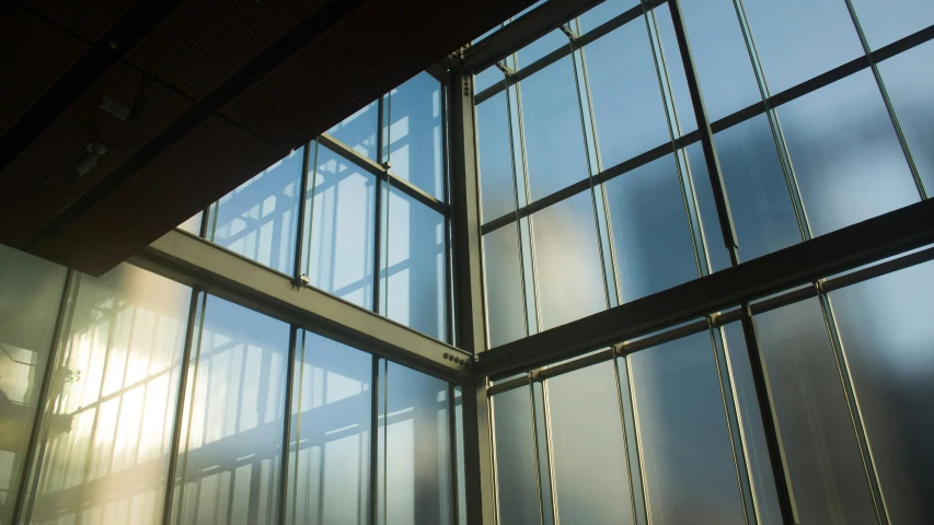 the sun shines through three large windows in the building