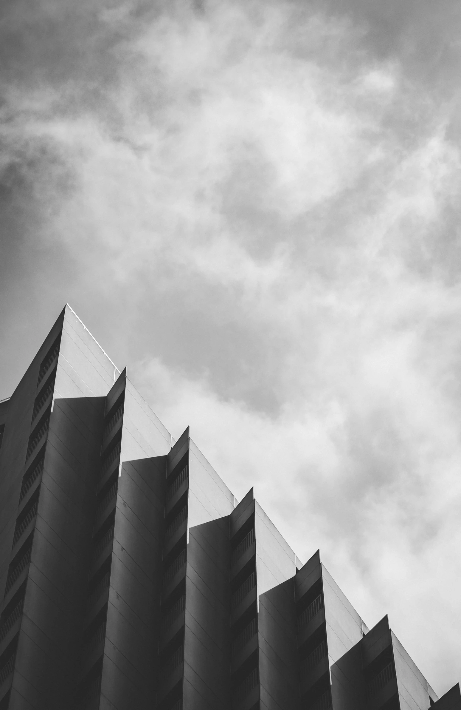 the corner of a building with a plane flying by