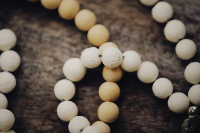 a necklace made with two balls of white marble