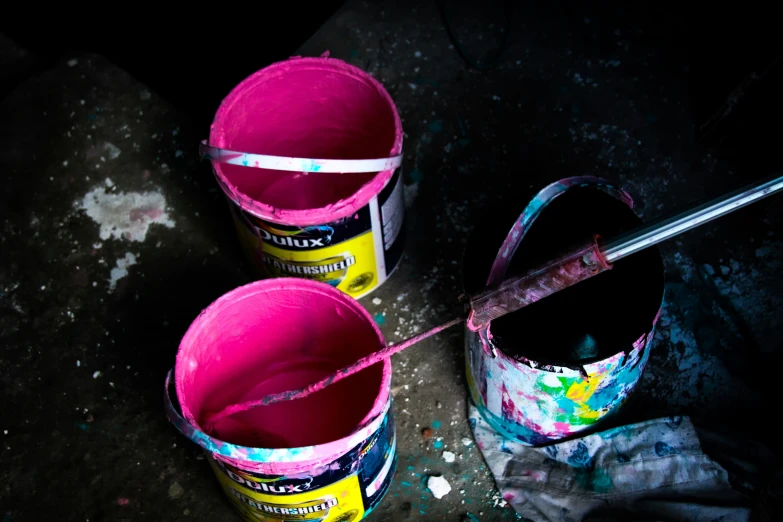 three buckets and a metal handle on the ground