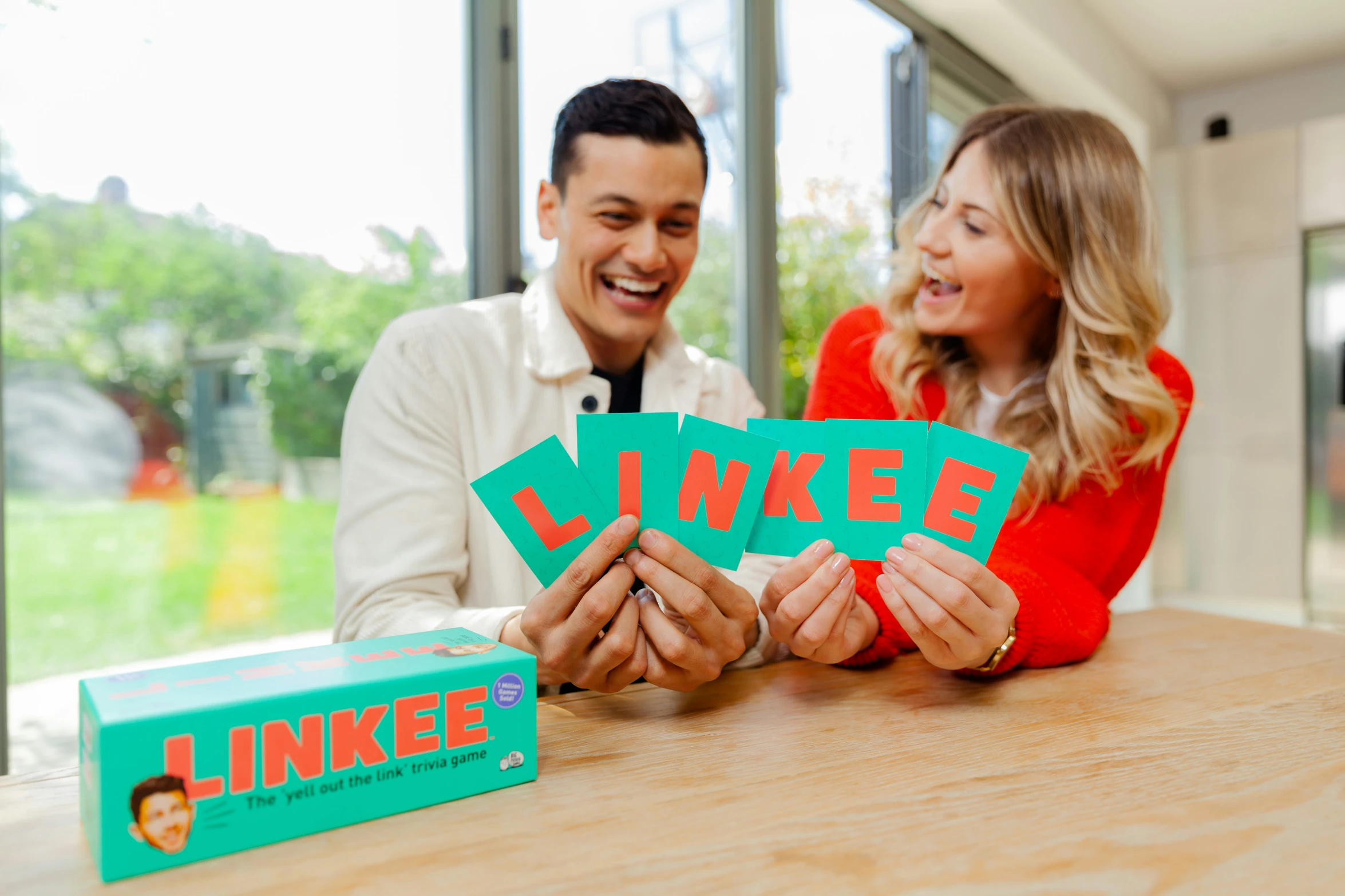 a man and a woman hold up a pair of letters with the word'i love'written in them