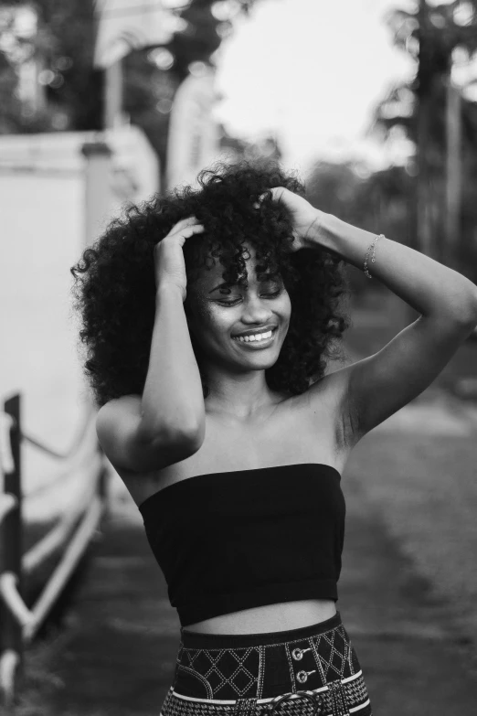 a woman poses on the street in black and white