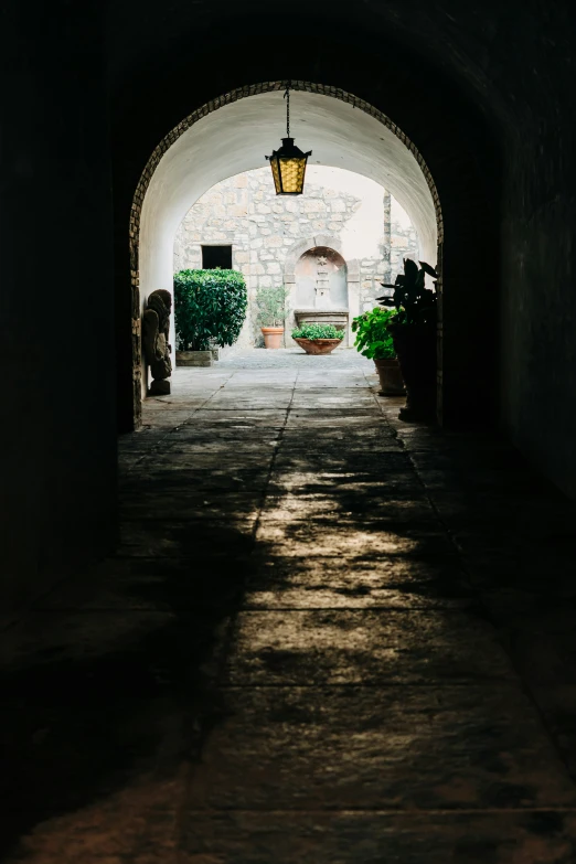 a long dark tunnel with light coming through it