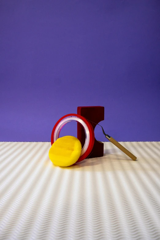 the back end of a pair of scissors is sitting next to the letters on a striped surface