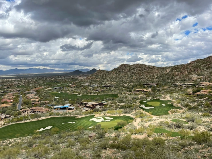 a scenic golf course with a green and mountains