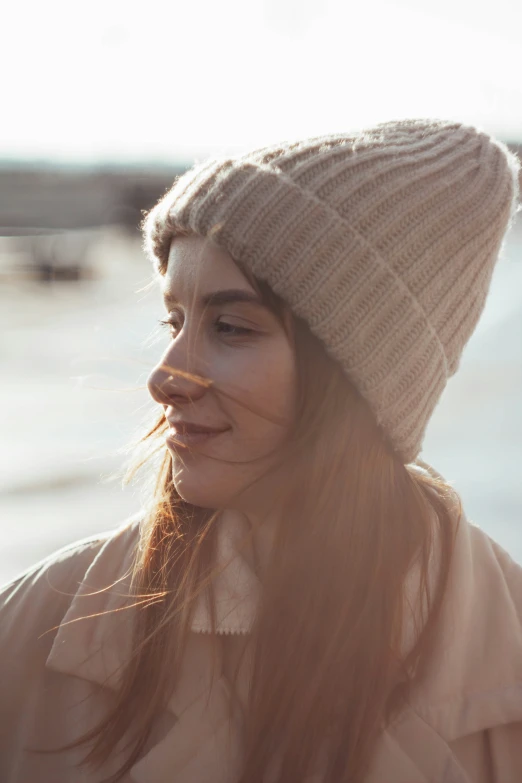 a woman with long hair and a beanie hat