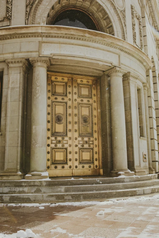 there is snow covering the ground by a big door