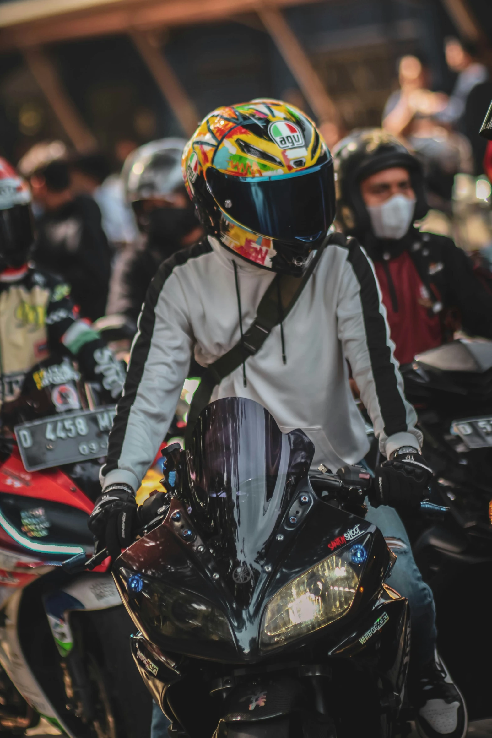 a motorcyclist wearing a yellow helmet and black gloves