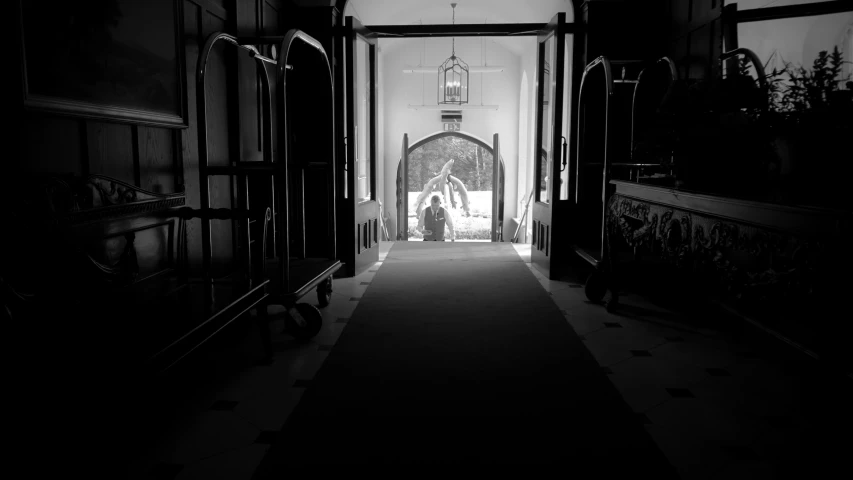 a man walking down the hall in an old house