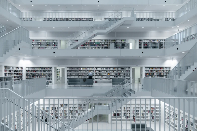 this po shows a staircase in the middle of an empty liry with shelves full of books