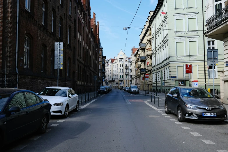 two cars parked on the side of a city street