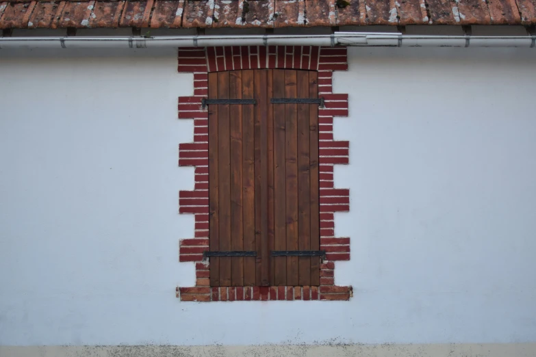 a red and white building has an open brown door