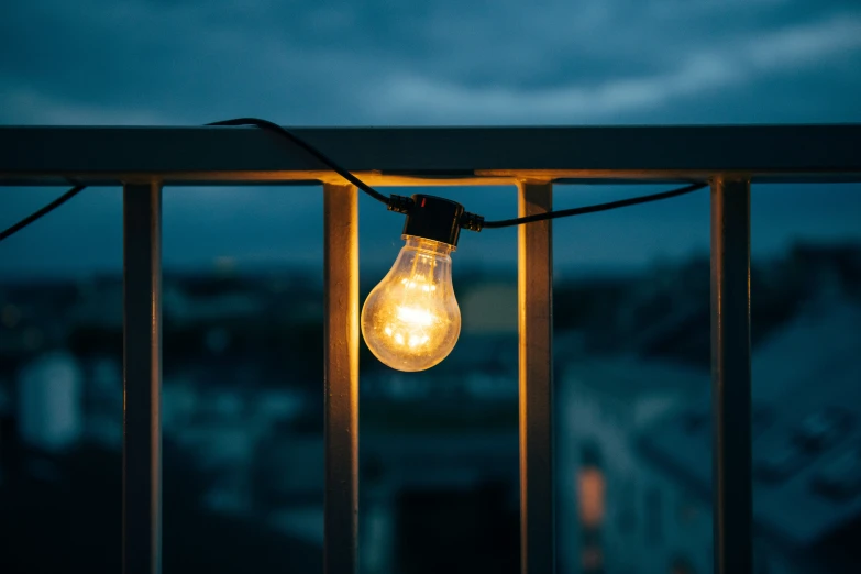 the light bulb is lit against a dark sky