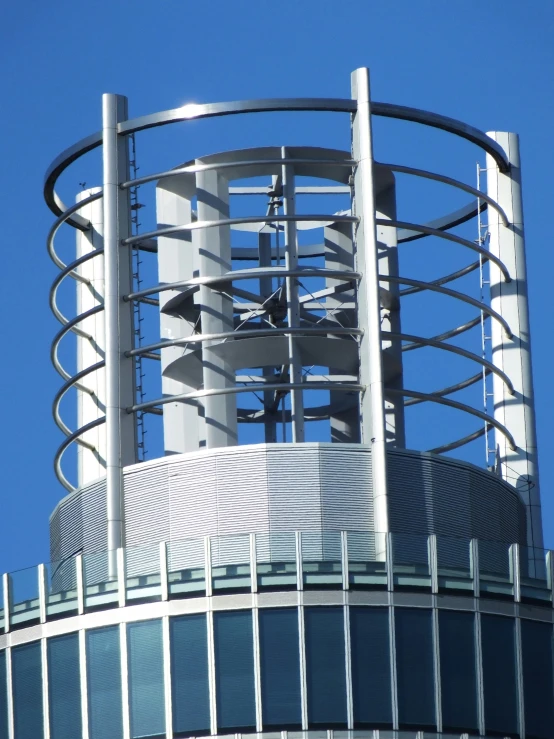 the top of a clock tower is visible against a clear blue sky