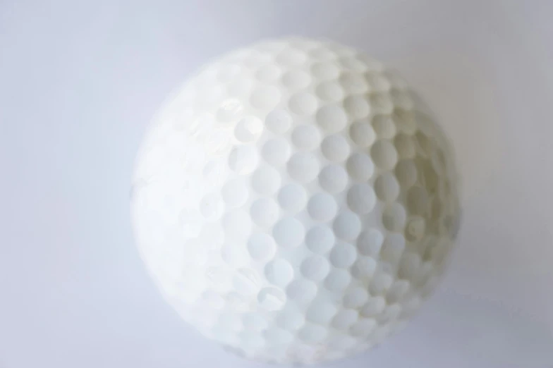 a close up of a golf ball on the wall