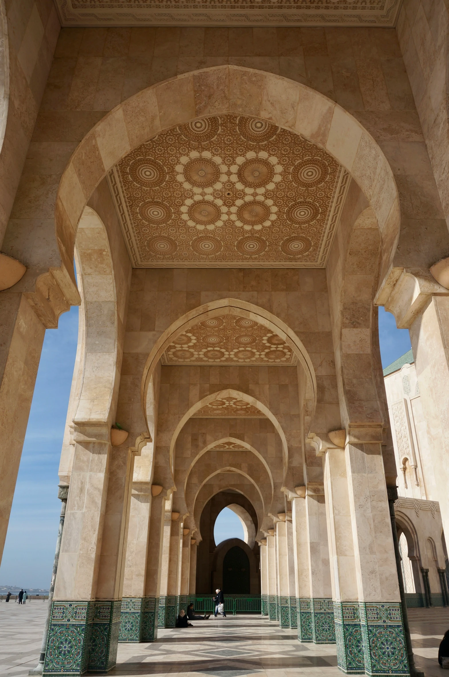 a huge hallway with arches and tiled walls