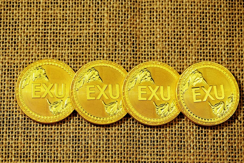four golden chinese coins sitting in a row