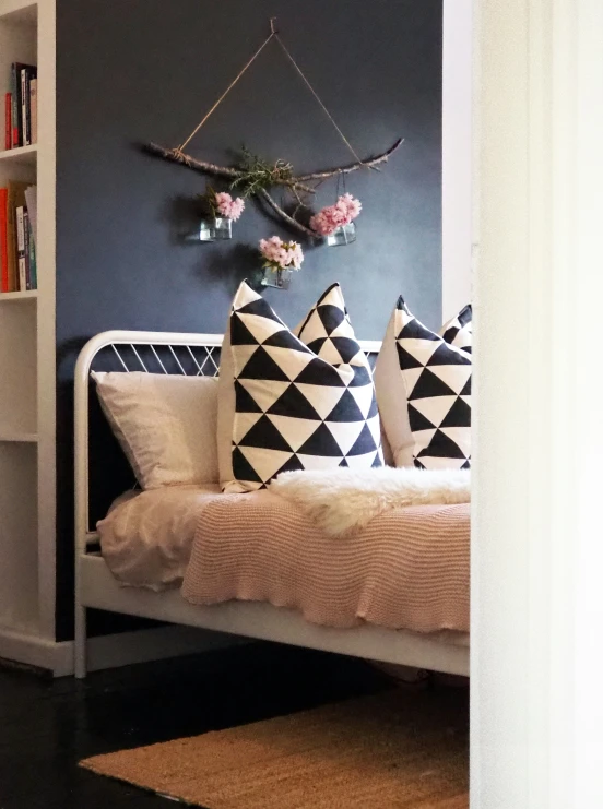 the view from a doorway of a bed with decorative pillows