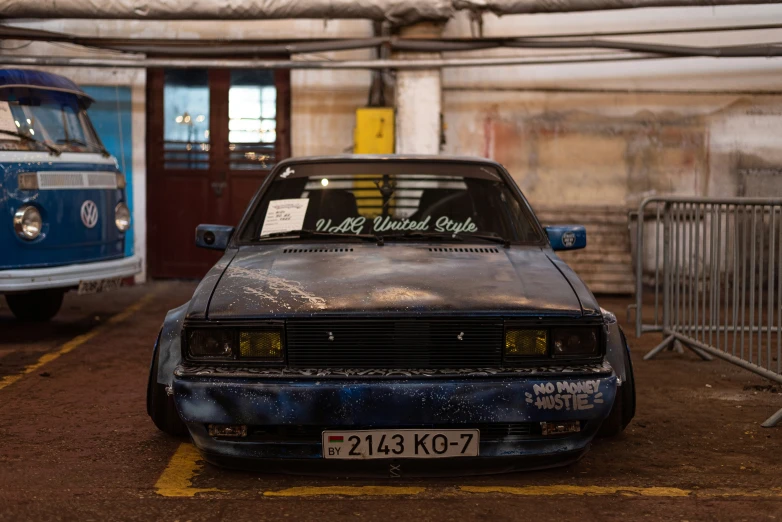 a old and rusty car in a parking lot