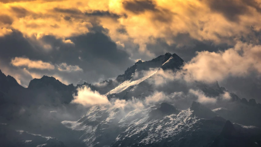 mountains are in the background surrounded by clouds