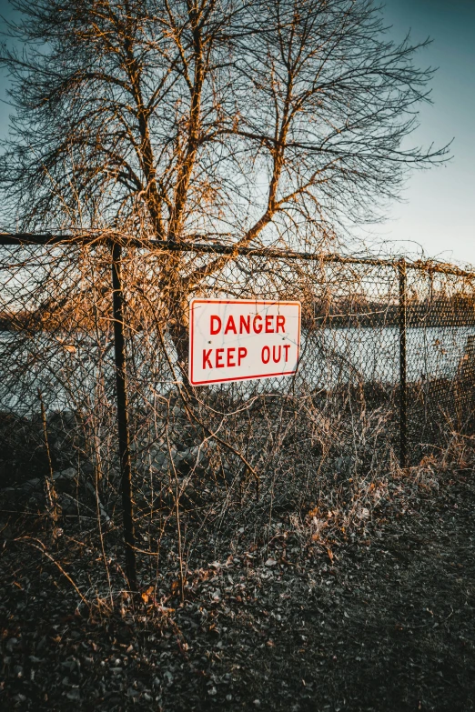 a red and white sign that says danger keep out