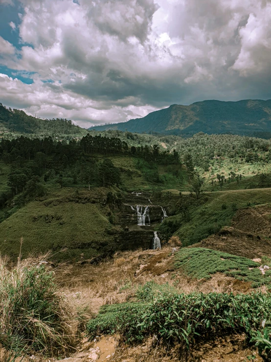 a scenic view of a river running through a lush green valley