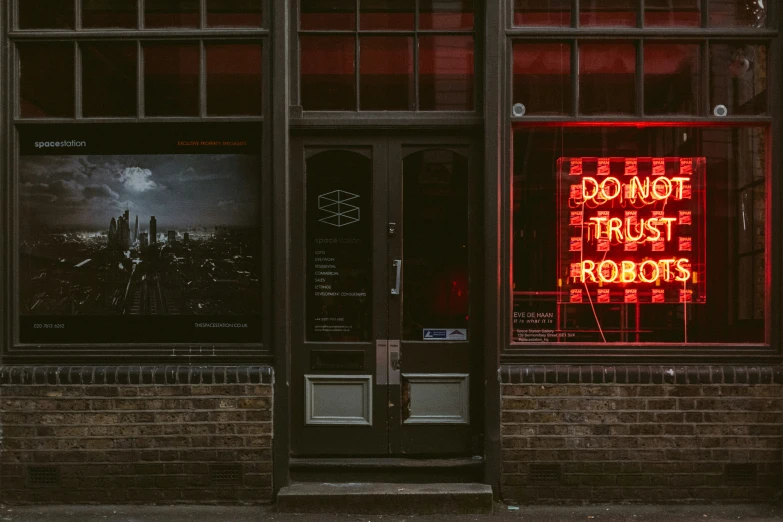 a donut shop has its lighted signs on the side