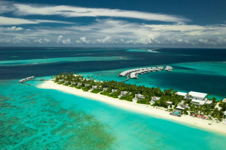 an island surrounded by green palm trees in the ocean