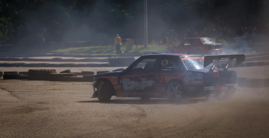 a man driving a car with smoke coming out of it