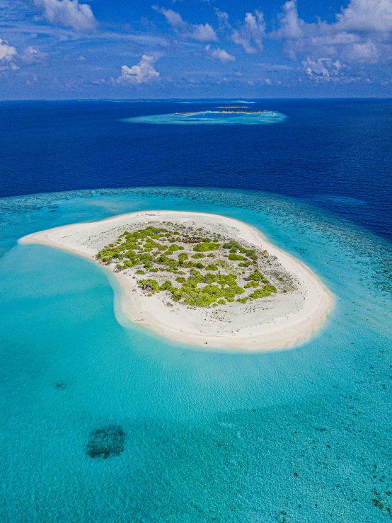 an island in the ocean with some sand on it