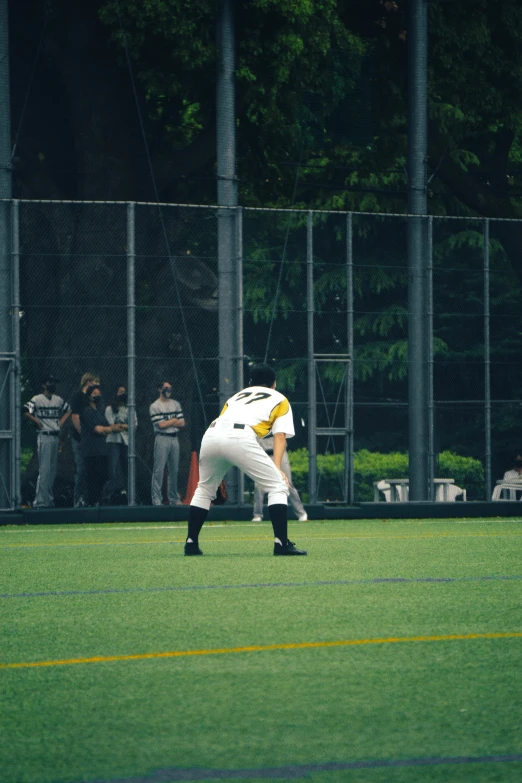 a baseball player bent over on the field