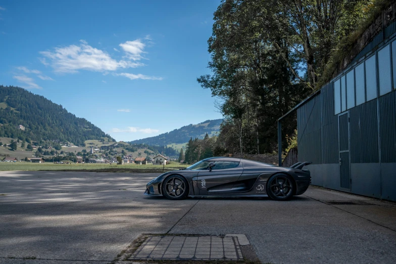 a sleek car is parked next to a black car