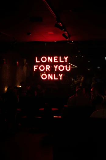 a neon sign reads lonely for you only at a restaurant
