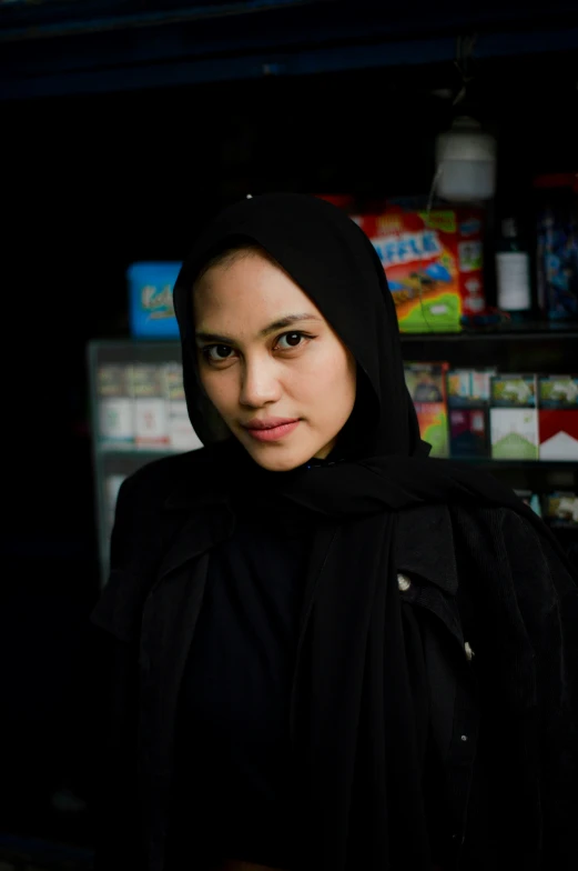 a woman in a black outfit stands in front of a store