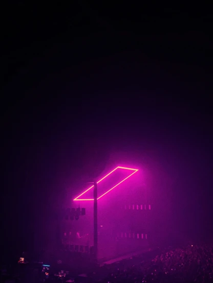 a purple neon sign in front of a building