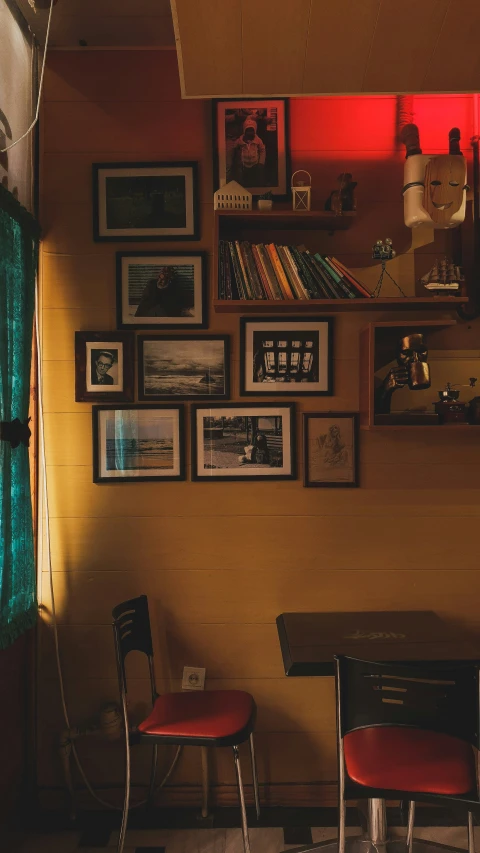 a table with two chairs under two red lights