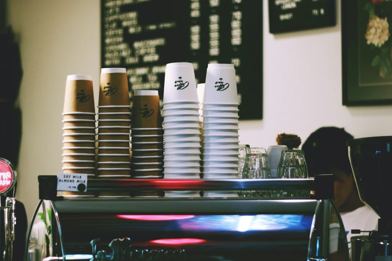 a restaurant counter with cups and plates on it