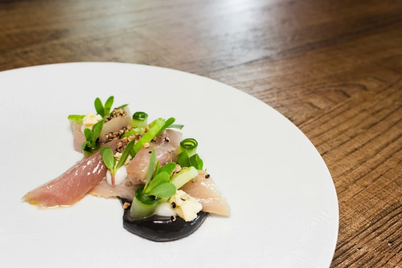 a white plate topped with food sitting on top of a wooden table