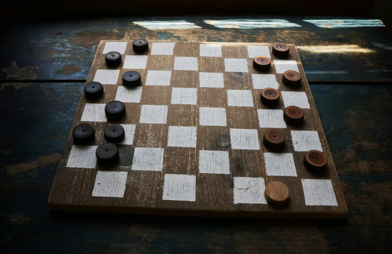 an antique looking chess board and pieces of black and white