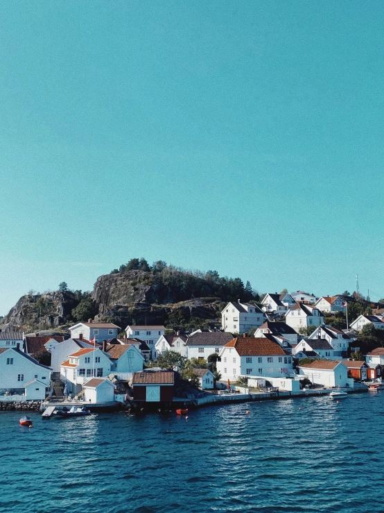 the shore of a lake with houses on it