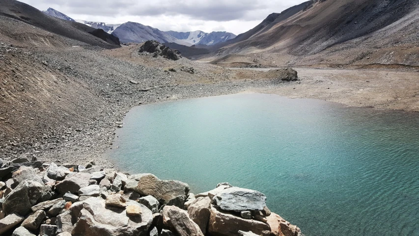 a large lake surrounded by rocky hills