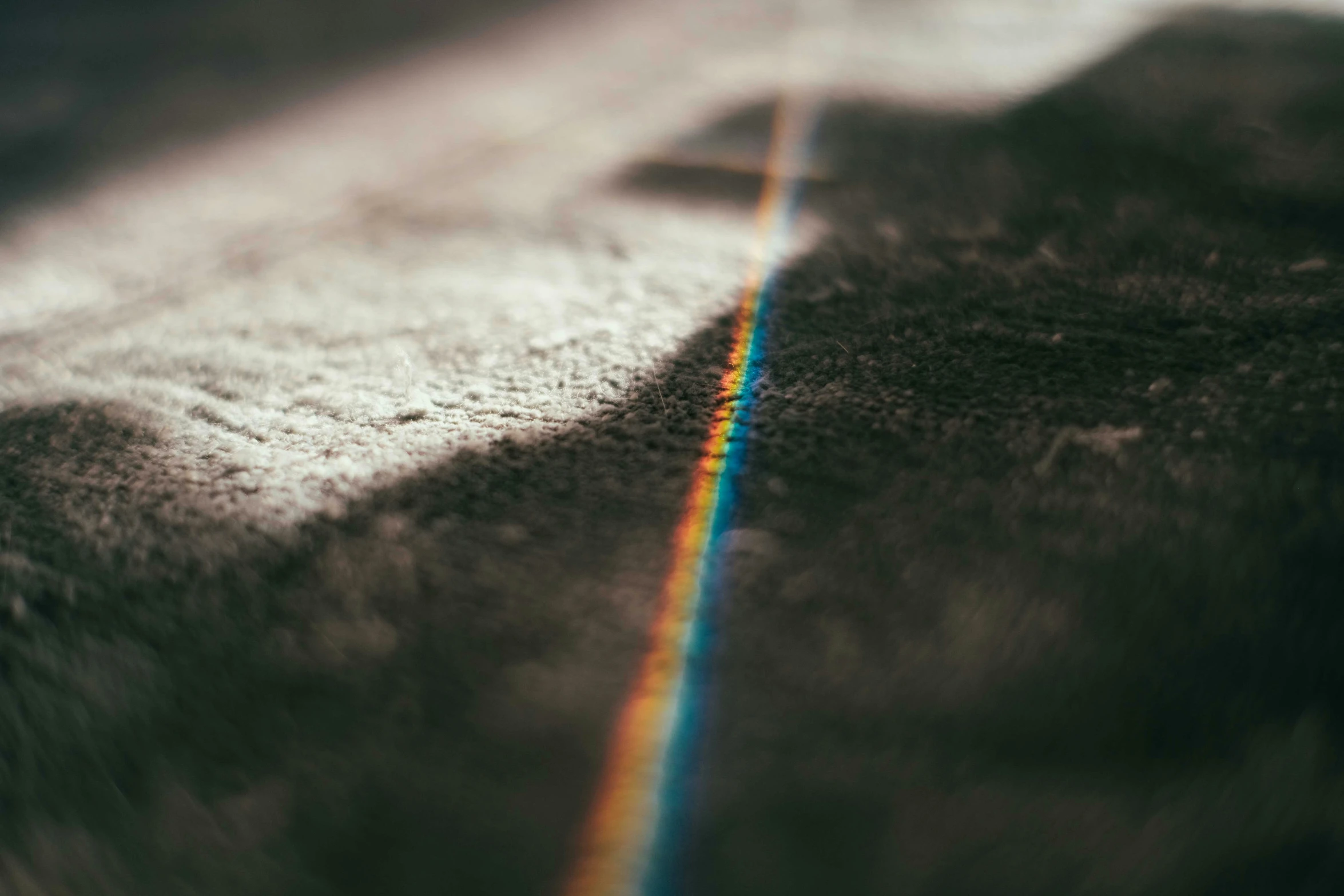 a rainbow line is painted on the side of a building