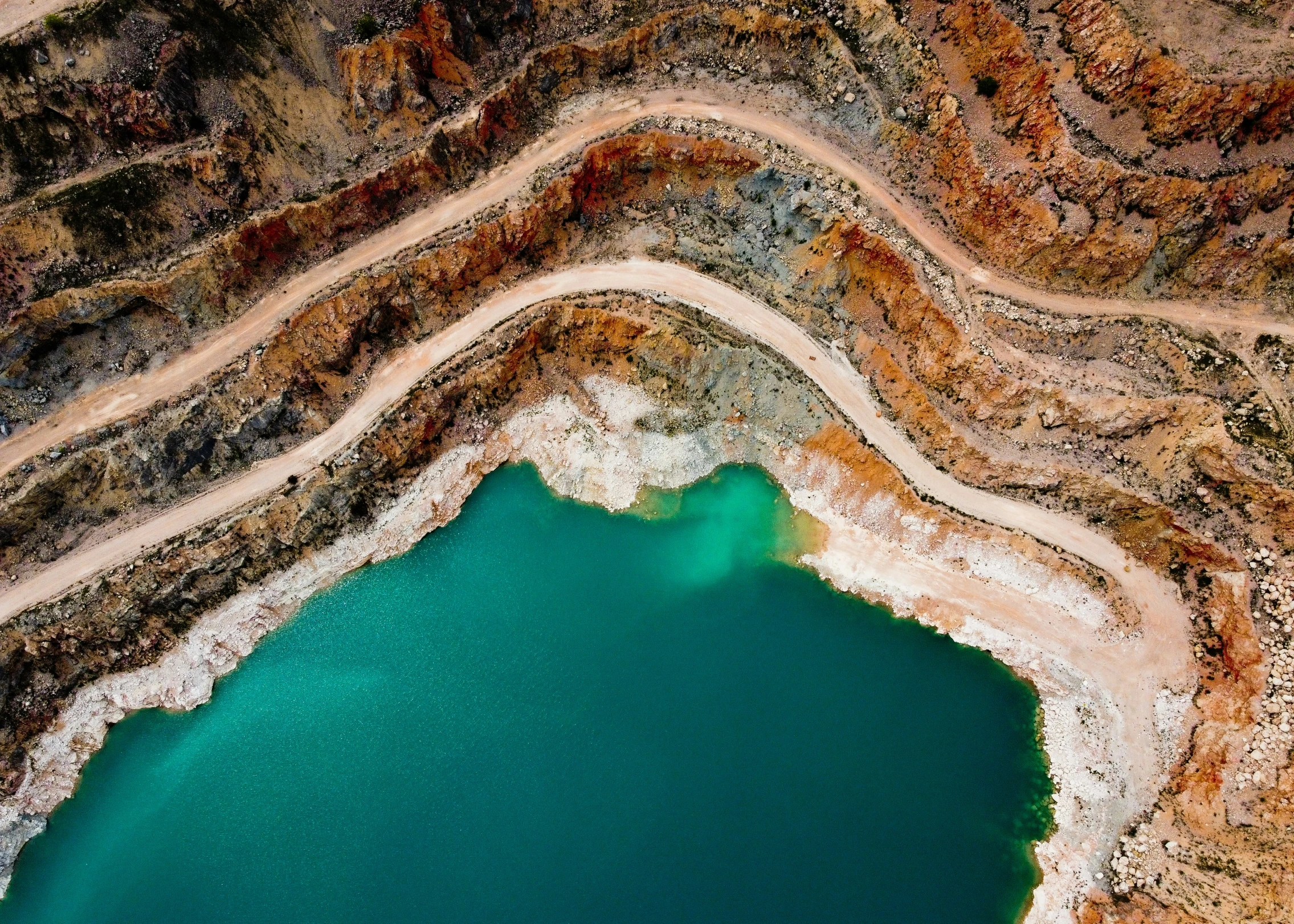 this is an aerial po of a blue lake in the mountains