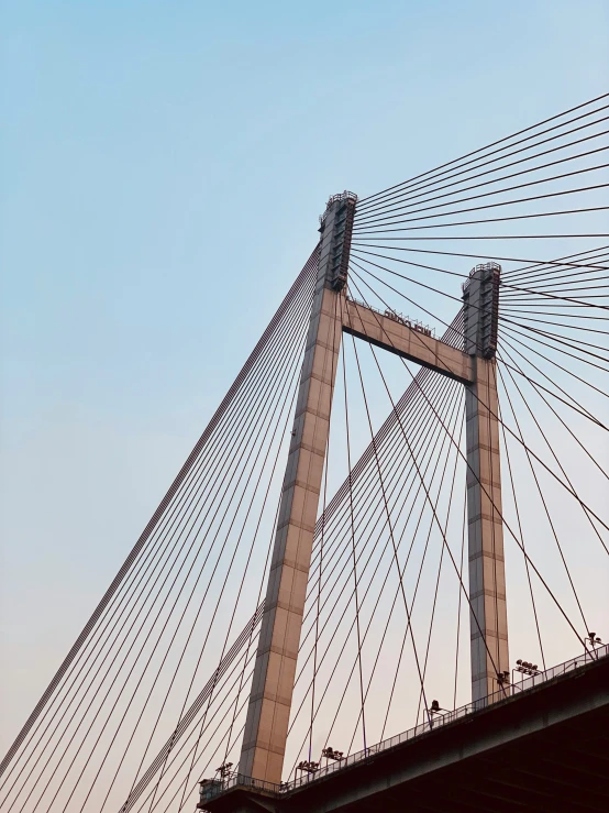 a long bridge with wires crossing over it