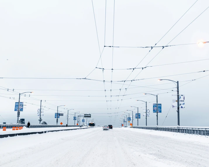 a street lined with signs and wires covered in snow