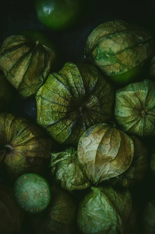 close up of some green apples and leafy leaves