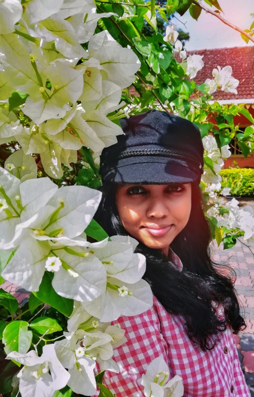 a person stands behind large white flowers