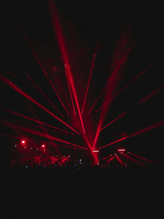 a night scene with many red lights coming from the ceiling